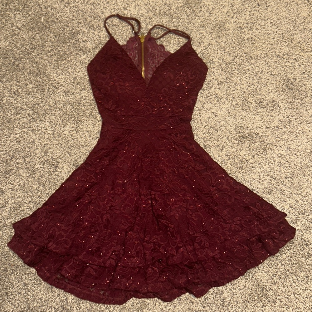 This is a formal or homecoming dress. It's a dark maroon with glitter.